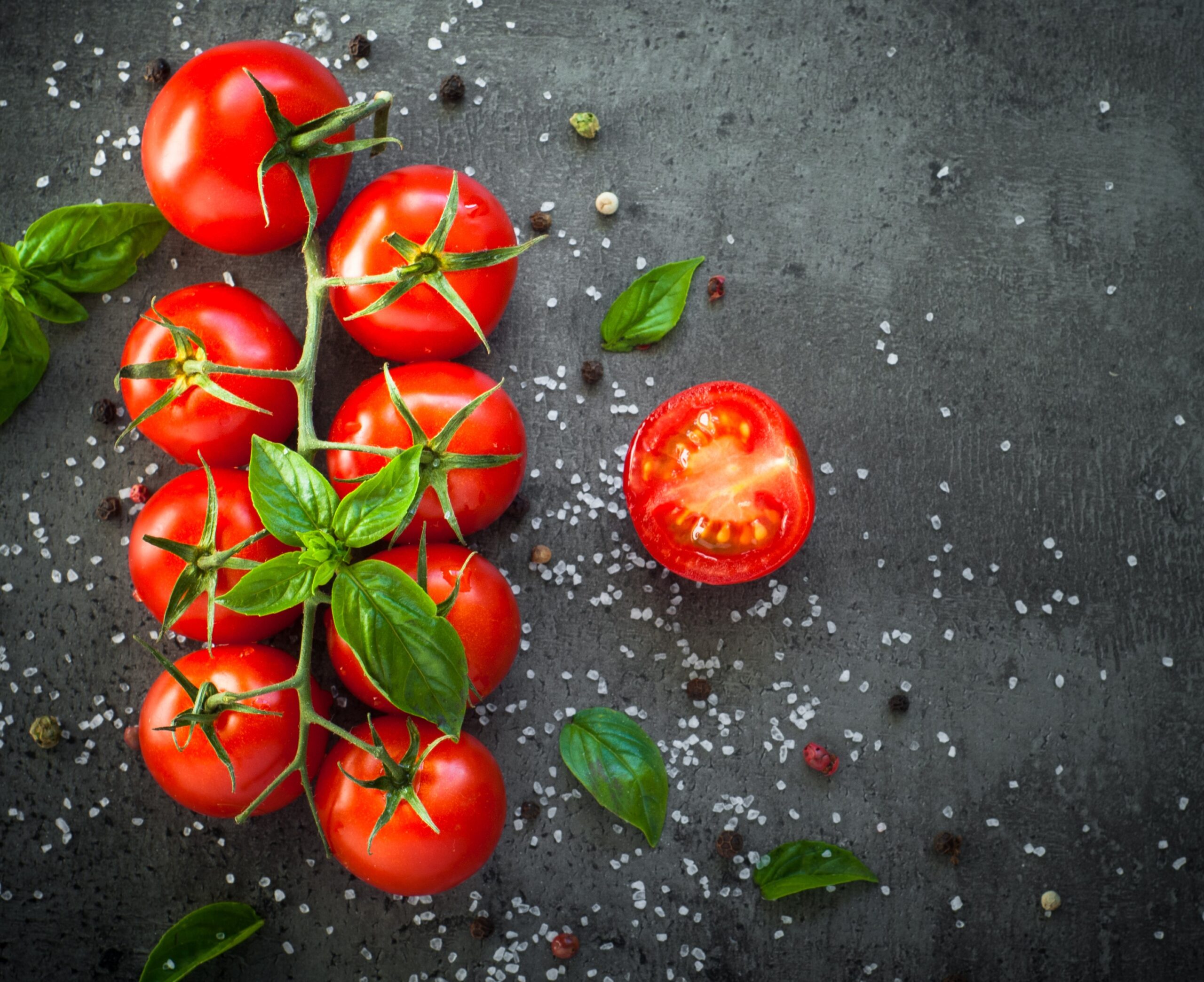 Fresh,Cherry,Tomatoes,On,A,Black,Background,With,Spices.,Top